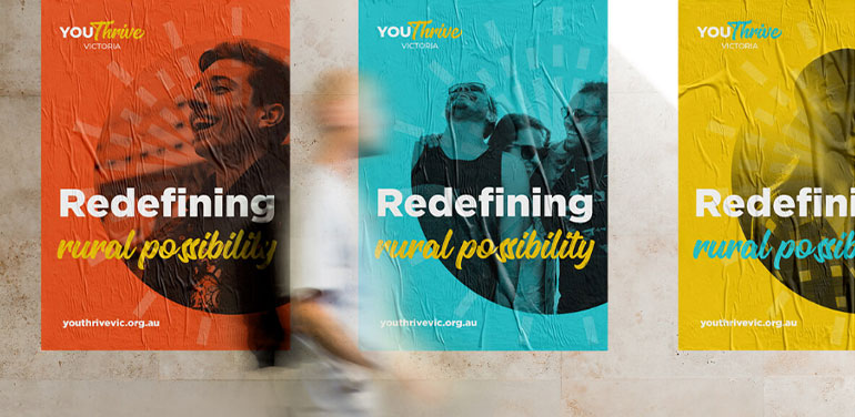 Blurred image of person walking past Youthrive posters
