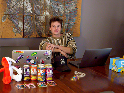Finn Wolff sits at his desk surrounded by clients' products