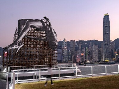 “GIANTS: Rising Up” Public Art Installation at Harbour City Shopping Mall depicts a gigantic high jumper floating in mid-air adjacent to Hong Kong’s iconic Victoria Harbour