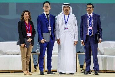 4 Dec 2023: Dr Entela Benz (leftmost) and award winners receiving the award from H.E. Khaled Mohamed Balama, Governor of the Central Bank of the UAE (3rd from left), onstage at the Global Climate Action Through Fostering Sustainable Finance panel in Al Waha Theatre during the UN Climate Change Conference COP28 at Expo City Dubai (Photo by COP28 / Mahmoud Khaled).